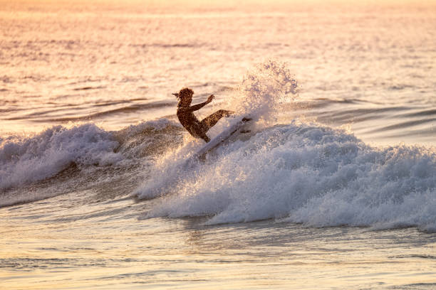 istock Sporty boy riding his surf board 1971255117