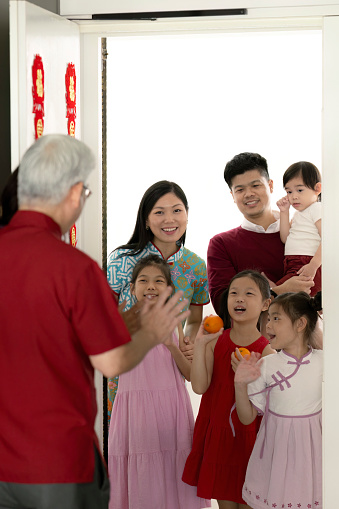 Vertical young family visiting grandparents during Chinese New Year