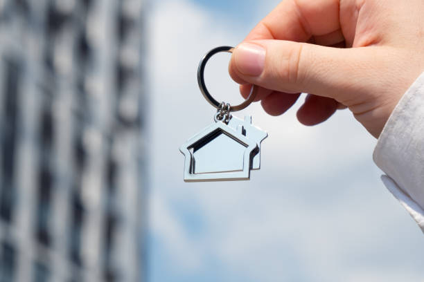 istock Hand holds a keychain that looks like a house 1971291148