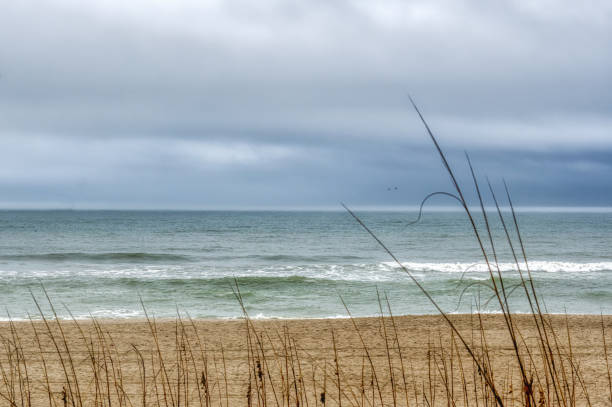 A blurred view of the Atlantic Ocean through the clear dunes at Wrightsville Beach, NC.