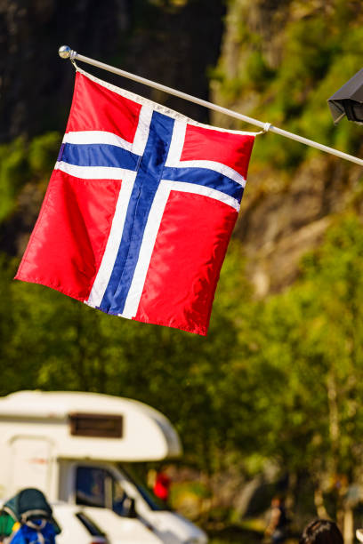 istock Norwegian flag and camper car in mountains 1971302032