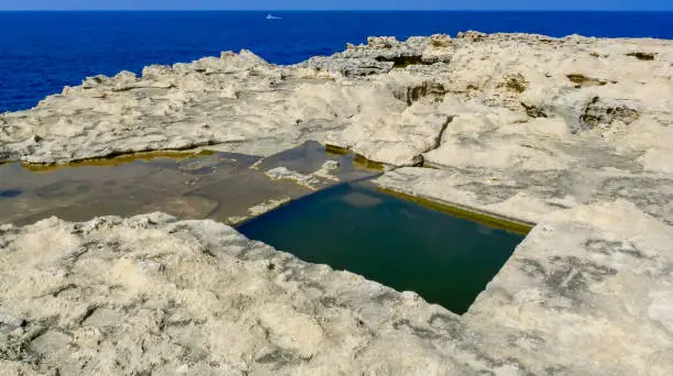 Photo of Pools carved into the stone shore on the island of Gozo, Malta