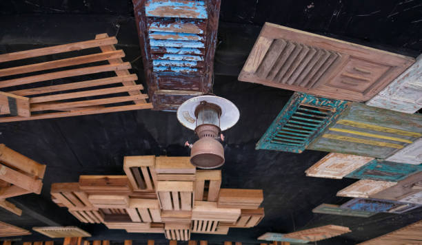 Old lantern hanging at decorative  vintage wooden ceiling.