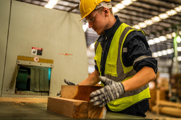 istock Factory engineer man working with timber material. Worker works at heavy machine at industry factory. with machinery equipment plant technology. smart industry worker operating. 1971360058
