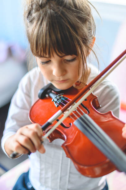 istock Young child, early elementary age girl practices playing the violin 1971385746