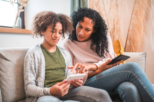 istock Mother-Daughter Time on the Sofa with E-Readers 1971389328