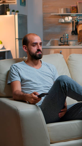 istock Concentrated man with beard watching movie show 1971392916