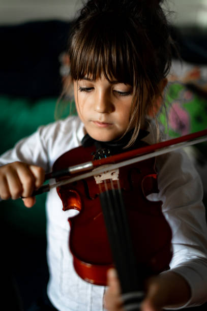 istock Young child, early elementary age girl practices playing the violin 1971392922