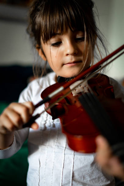 istock Young child, early elementary age girl practices playing the violin 1971402314