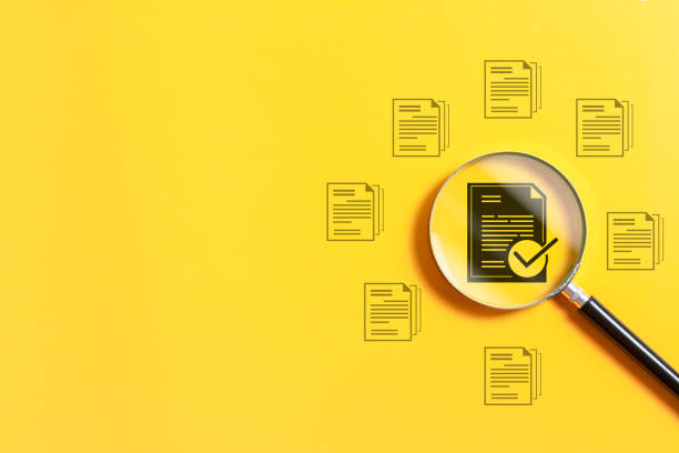 istock Magnifying glass focus to approved document icon on yellow background for approve business project proposals. Quality assurance and evaluation of business concept. 1971403885