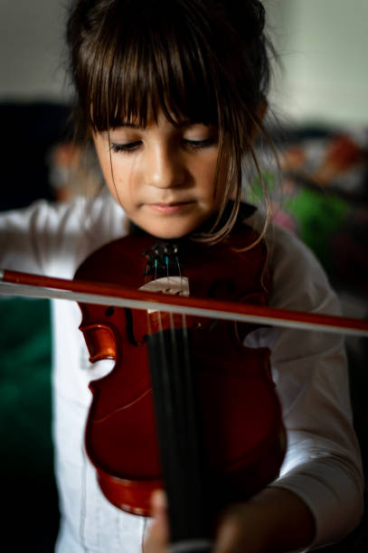 istock Young child, early elementary age girl practices playing the violin 1971404415