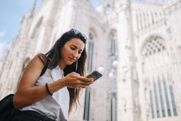 istock checking maps on smartphone in Milan, Italy 1971430876