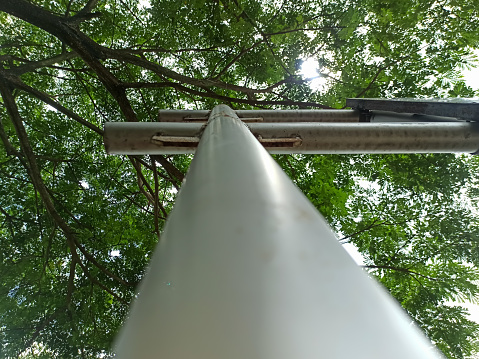 The iron guidepost seen from below rises high.