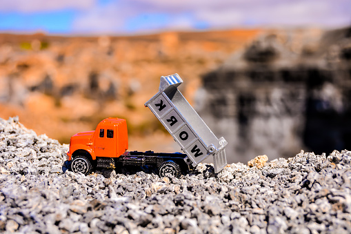 Conceptual Photo Picture of a toy car in the dry desert
