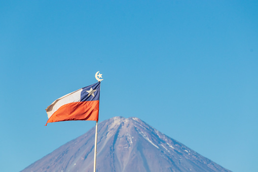Chilean Flag Waving with Licancabur Volcano in the Background.