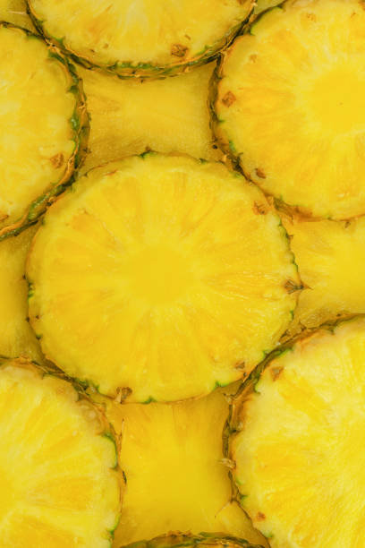 istock Pineapple juicy yellow slices as a background. 1971519396