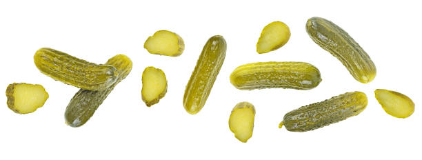 istock Delicious marinated pickled cucumbers and slices isolated on a white background, view from above. 1971521081