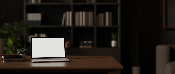 istock A white-screen laptop computer mockup on a hardwood desk in a modern private office. 1971558534
