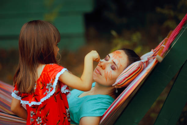 Tired Mom Sleeping While Little Daughter Draws her Face