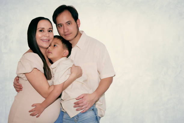 istock Pregnant woman hugging son and husband 1971625759