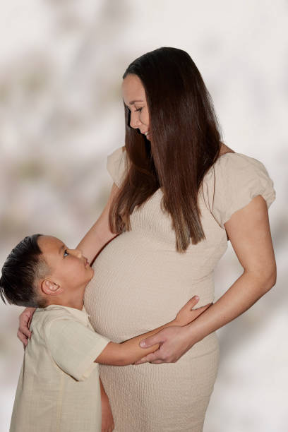 Young pregnant mother with her son