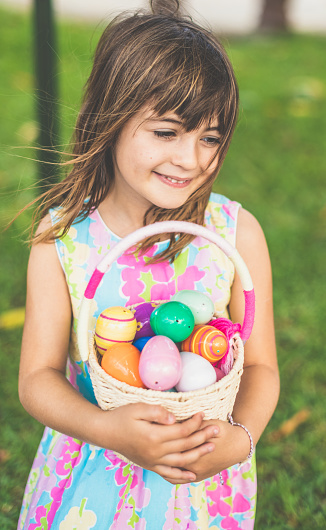 Happy little girl at Easter egg hunt