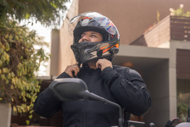 istock Indian biker puts on his helmet before getting on his motorbike 1971722360