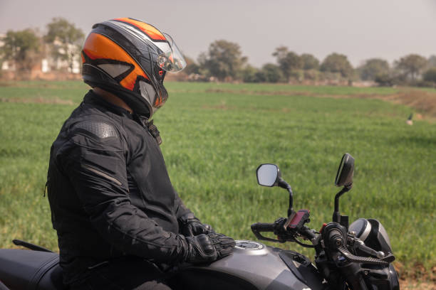 istock Indian biker taking a break looking out at open fields on rural roads 1971723397