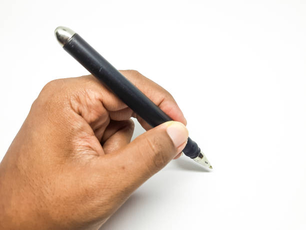 istock Left hand of a man holding a pen for writing on an isolated background 1971726457