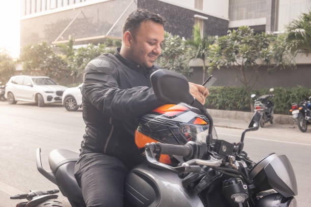 istock Indian biker taking a break with the city streets in the background 1971729105