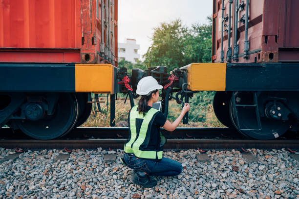 istock Engineer railway wearing safety uniform and helmet under checking train ,wheels and control system for safety transportation. 1971756422