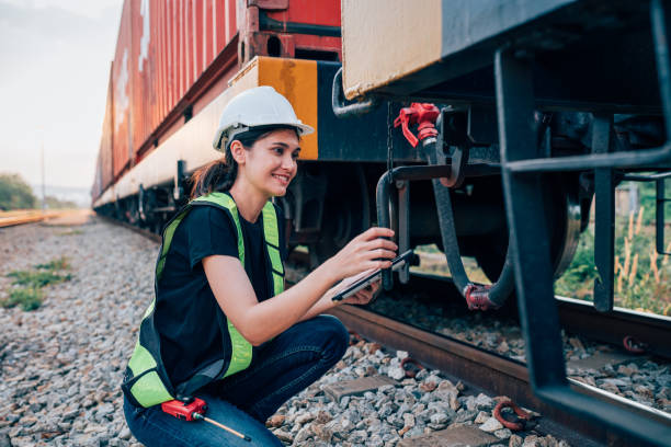 istock Engineer railway wearing safety uniform and helmet under checking train ,wheels and control system for safety transportation. 1971756423