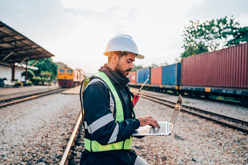 Engineer wearing safety uniform sitting on railway inspection. construction worker on railways. Engineer working on Railway. Rail, engineer, Infrastructure.