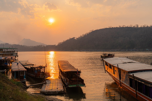 Scenic view of boats on Mekong River at sunset