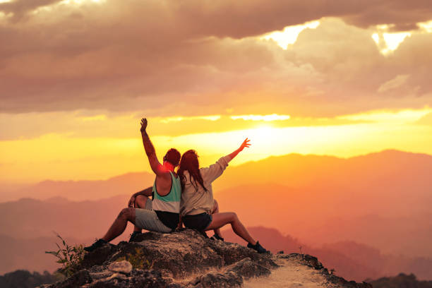 istock Happy couple enjoys sunset at mountain top 1971796035