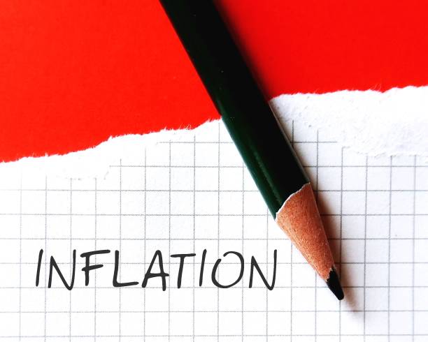 istock On red background, pen writing words on notebook INFLATION, means increase in the prices of goods and services in economy- decreasing the purchasing power of money 1971818834