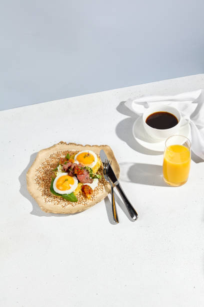 istock Potato pancakes with savory roast beef and sunny side up eggs, served with a refreshing glass of orange juice and a cup of coffee 1971824156