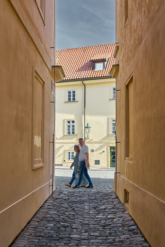 Prague, Czech Republic – October 02, 2023: Narrow alley with vacationers in the city center on the Vltava island Kampa in the middle of the Mala Strana district, Lesser Town in Prague