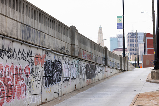 Kansas City, Missouri, USA - June 15, 2023:  Afternoon light shines on a graffitied wall in downtown Kansas City.