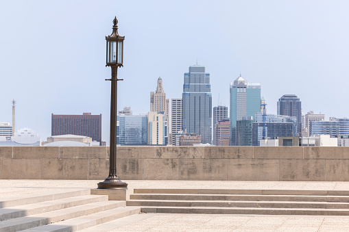 A historic street lamp frames a morning view of the downtown skyline of Kansas City, Missouri, USA.