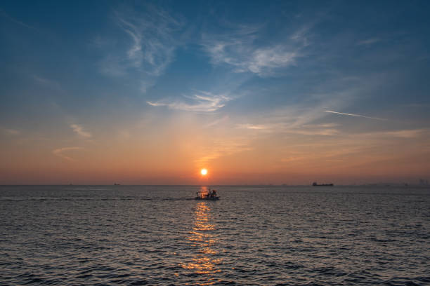 istock fishing boat going in the open sea at sunset 1971829661