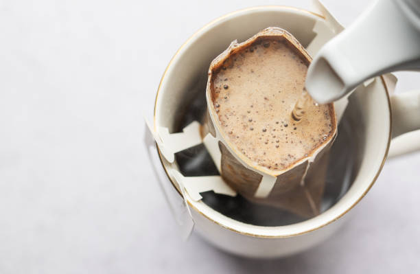 istock Drip coffee bag with ground coffee in  cup 1971836131
