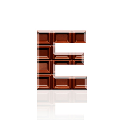 Close-up of three-dimensional chocolate bar alphabet letter E on white background.