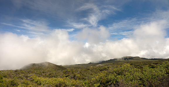 Standing on the higher ground above the clouds concept, panoramic view from the Top of Haleakala volcano with beautiful mountain valley on Maui Hawaii