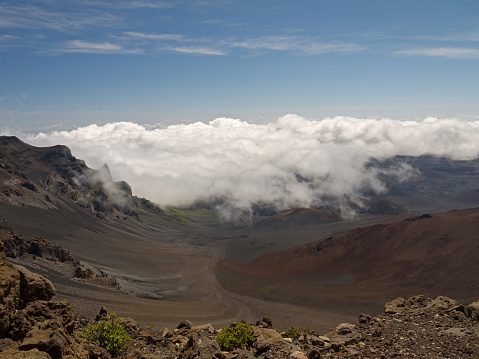 Standing on the edge of Haleakala volcano with nice clouds inside the giant crater, Maui, Hawaii