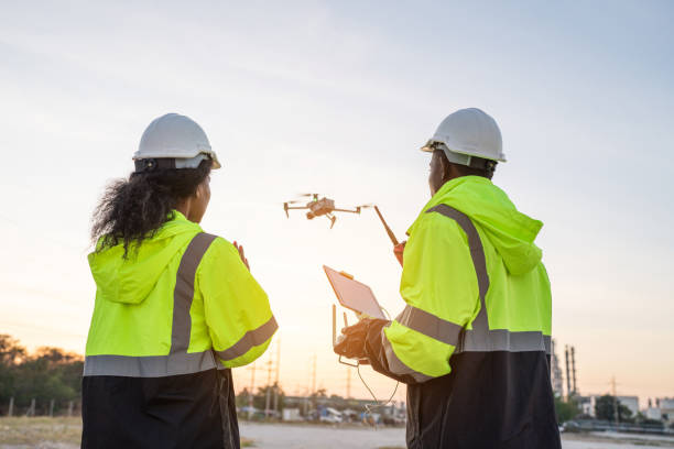istock Team of Engineer Specialists Pilot Drone on Construction Site. 1971872186