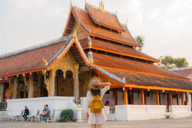 istock Woman exploring buddhist temple in Laos 1971877336