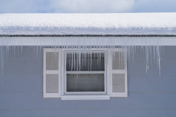 winter house with icicle and snow on the roof