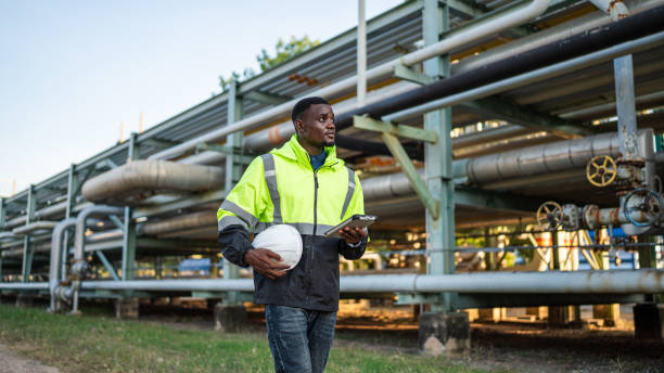 Mechanical engineer working and holding tablet to checking and inspection gas pipeline system.