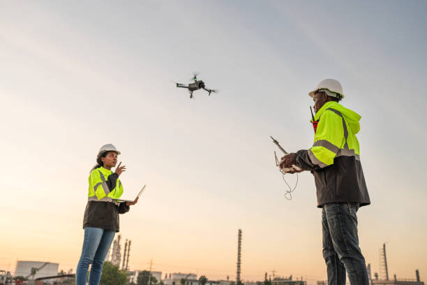 istock Team of Engineer Specialists Pilot Drone on Construction Site. 1971890215